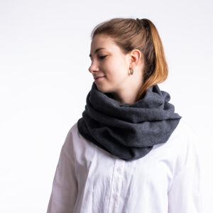 Winter scarf . A photo of a model wearing the vegan winter scaf in Charcoal.