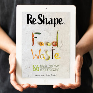 The photo of Kate Bartel holding the tablet with ReShape. Food Waste cookbook cover displayed ReShape. Food Waste is a zero-waste and vegan cookbook by Kate Bartel