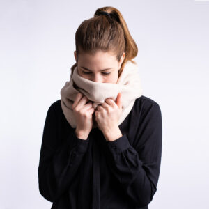 Winter scarf . A photo of a model wearing the vegan winter scaf in Creamy Beige